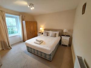 a bedroom with a large bed and a window at Fintry Inn in Fintry