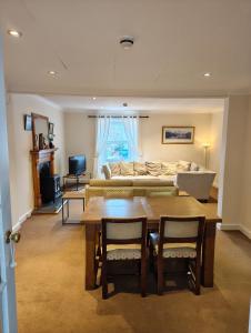 a living room with a table and a couch at Fintry Inn in Fintry