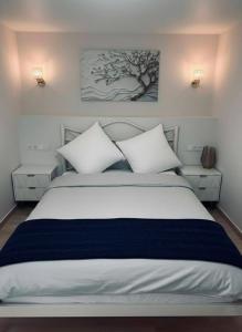 a bedroom with a large white bed with pillows at Malishka Eco Villas  +17 photos