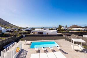 a villa with a swimming pool and a view of the ocean at Villa Yaiza Secret 3 in Yaiza