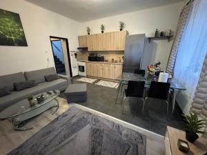 a living room with a couch and a table at Apartment PMS in Veľká Mača