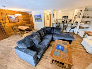 a living room with a couch and a table at Montezuma 1770 by SummitCove Lodging in Colorado in Keystone