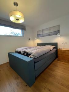 a bedroom with a blue bed in a room at The view - Helfenberg in Ilsfeld