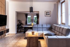 a living room with a couch and a table at Vila Grad Bled - Sauna & Hot tub in Bled