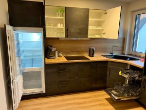 an empty kitchen with a refrigerator and a sink at Studio Lippstadt 97, Balkon, Parkplatz, Küche, TV, Waschmaschine in Lippstadt