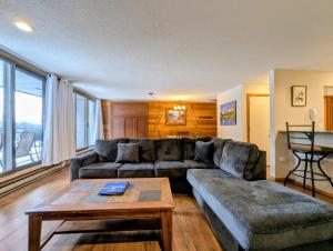 a living room with a couch and a table at Montezuma 1770 by SummitCove Lodging in Colorado in Keystone