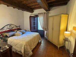 a bedroom with a bed in a room with a window at La Loggia di Montefienali in Gaiole in Chianti +63 photos