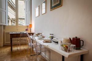 a kitchen with a counter with dishes on it at Palazzo De Giorgi B&B in Lecce