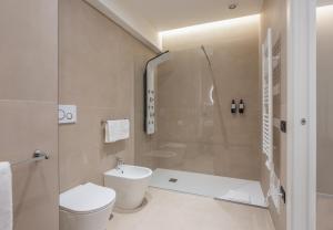 a bathroom with a shower and a toilet and a sink at Cali Luxury Suites in Caserta +38 photos