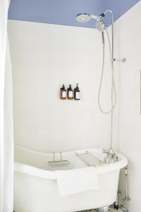 a bathtub in a bathroom with a blue ceiling at The Jellybean Heritage Inn in St. John's +70 photos