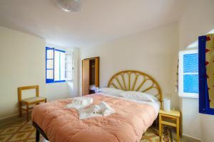 a bedroom with a bed with two towels on it at CaTorre 14 in Riomaggiore +20 photos