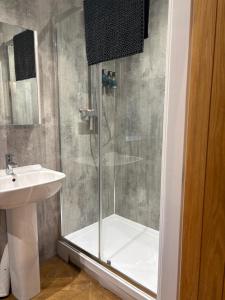 a bathroom with a shower and a sink at The Milking Parlour, Wolds Way Holiday Cottages, 1 bed cottage in Cottingham +13 photos
