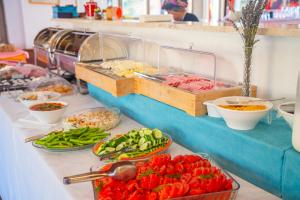 a buffet line with bowls of food and vegetables at Otel Kefalos in Gokceada Town