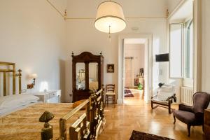 a bedroom with a large bed and a mirror at Palazzo De Giorgi B&B in Lecce