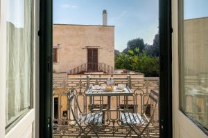 a view from a window of a table and a building at Palazzo De Giorgi B&B in Lecce