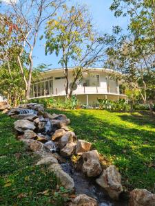 a rock garden in front of a house at Mooncake house khaoyai in Ban Bung Toei
