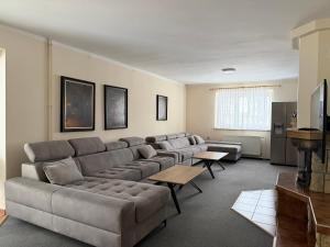 a living room with a large couch and a table at Chata pod Radhoštěm in Trojanovice