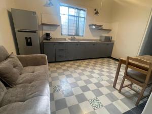 a living room with a couch and a kitchen at Apartartamento Centrico 27 Chapala in Chapala +5 photos