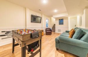 a living room with a foosball table and a couch at Dolphin's Song -Corolla, Villages at Ocean Hill, 350 Yds to Beach, Pets OK, Hot Tub, Community Pools in Corolla