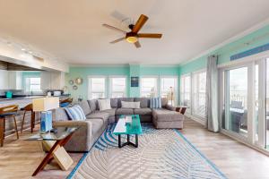 a living room with a couch and a ceiling fan at Paradise Shores 200 in Mexico Beach