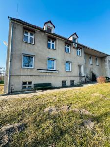 a large building with a yard in front of it at Apartamenty przy Galerii in Kluczbork