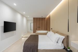a bedroom with a bed and a tv and a tub at Cali Luxury Suites in Caserta