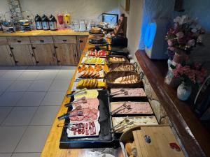a long table filled with different types of food at Pousada das Pedras in Monte Verde