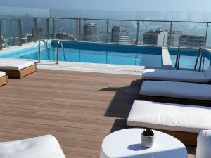 a swimming pool on the roof of a building at Inca inn apartments in Lima