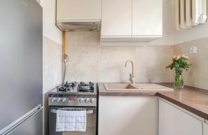 a kitchen with a stove and a sink at Chmielna Residence in Warsaw +13 photos