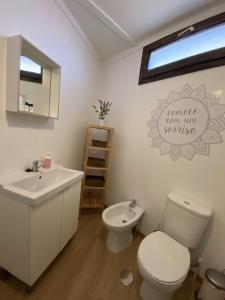 a bathroom with a toilet and a sink at YMCA Camp Alambre in Azeitao