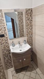 a bathroom with a sink and a mirror at Casa LuLù in Catanzaro