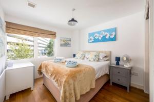 a white bedroom with a bed and a window at Castle Lanes - Minutes from Poole Quay, Poole Town Location in Poole