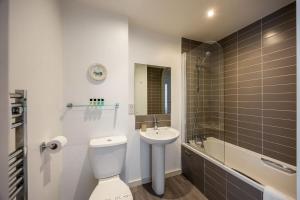 a bathroom with a toilet and a sink and a tub at Castle Lanes - Minutes from Poole Quay, Poole Town Location in Poole