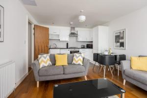 a living room with a couch and a table at Castle Lanes - Minutes from Poole Quay, Poole Town Location in Poole +19 photos
