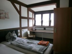a bedroom with a bed and a window and a desk at Hotel Glindenberger Hof in Glindenberg +46 photos