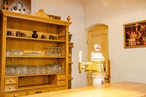 a room with a wooden cabinet with glasses on it at Kovárna in Nová Paka
