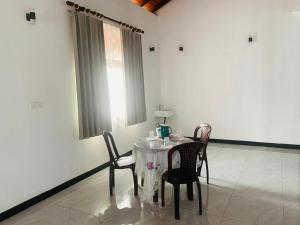 a dining room with a table and two chairs at Anjana Villa in Katunayaka