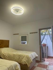 a bedroom with two beds and a ceiling fan at Aires de la Alpujarra in Alcolea
