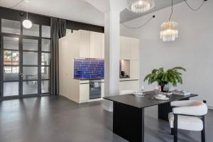 a kitchen with a table and chairs in a room at Starlight Loft Lucerne, World Above Chapel Bridge in Lucerne