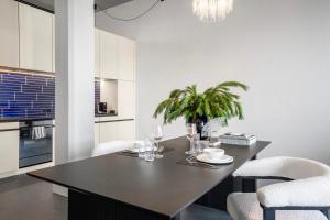 a dining room with a table and chairs and a kitchen at Starlight Loft Lucerne, World Above Chapel Bridge in Lucerne +7 photos