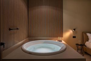 a large bath tub in a room with a bed at Cali Luxury Suites in Caserta