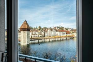 a view of a city from a window at Starlight Loft Lucerne, World Above Chapel Bridge in Lucerne