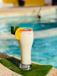 a drink with an orange slice on top of a towel at La Brise de Ngaparou in Ngaparou
