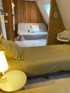 a bedroom with two beds and a table and a chair at 't Hof van Wespert in Westdorp
