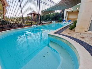 a swimming pool with blue water in a building at قصر فنيسيا 6غرف للإيجار ViP Vienice Palace luxury in 6th Of October