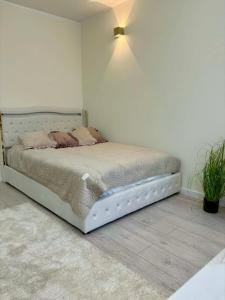 a bedroom with a bed in a white room at Leo Apartament in Konin