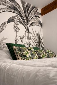 a bedroom with a bed with a mural of plants at Suite historique classée Avignon intra-muros in Avignon