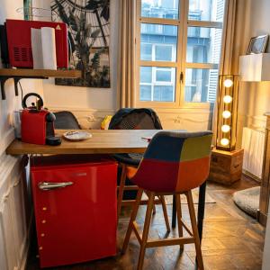 a kitchen with a table and two chairs and a desk at Suite historique classée Avignon intra-muros in Avignon
