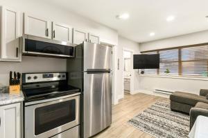a kitchen with a stainless steel refrigerator at Aisling Suites in Great Falls