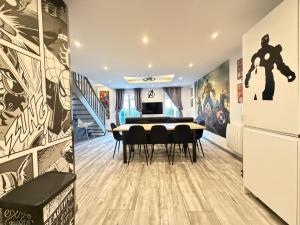 a dining room with a table and black chairs at Disney Avengers House in Magny-le-Hongre